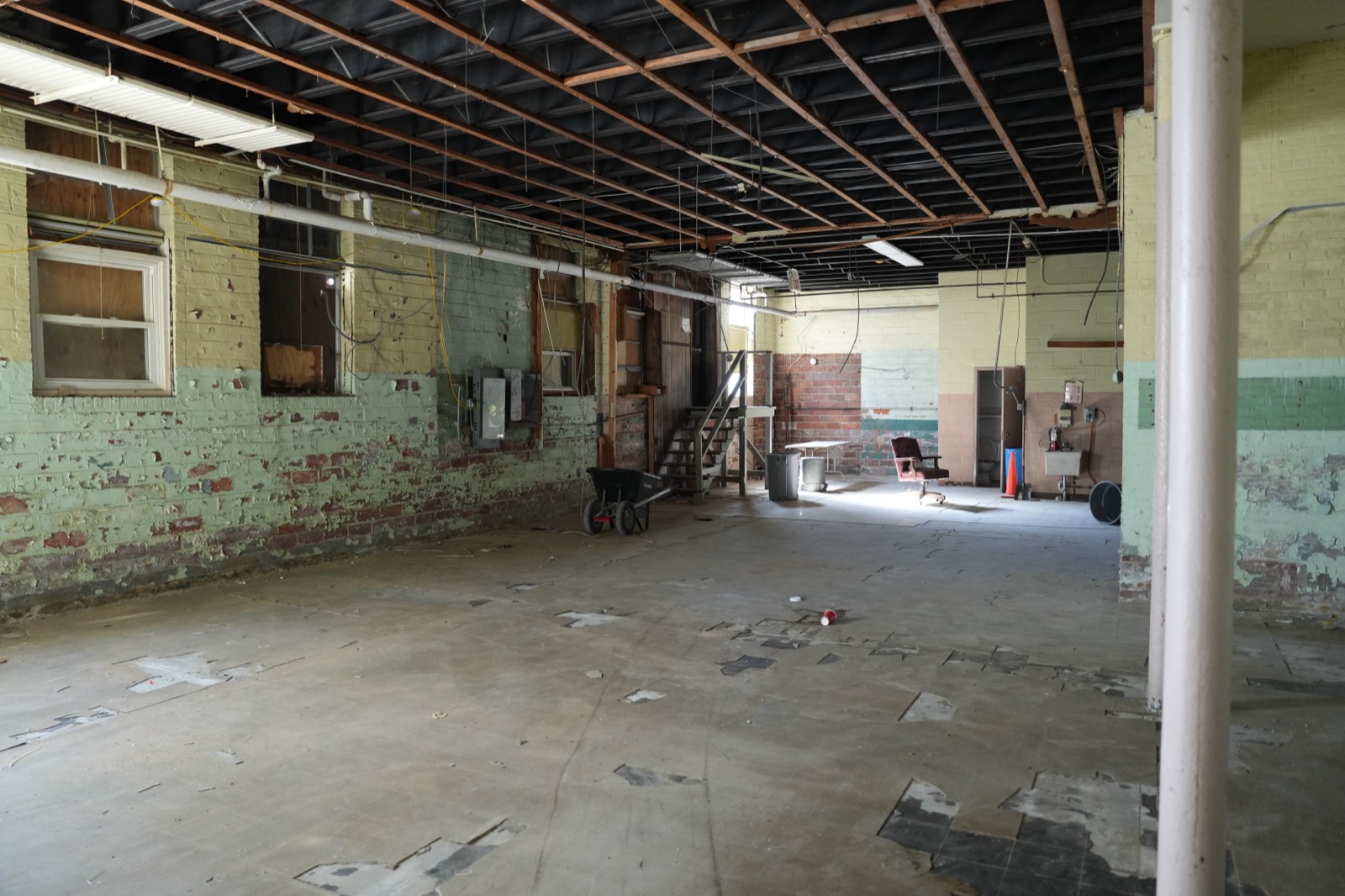 A large open hall inside, cleared for renovation